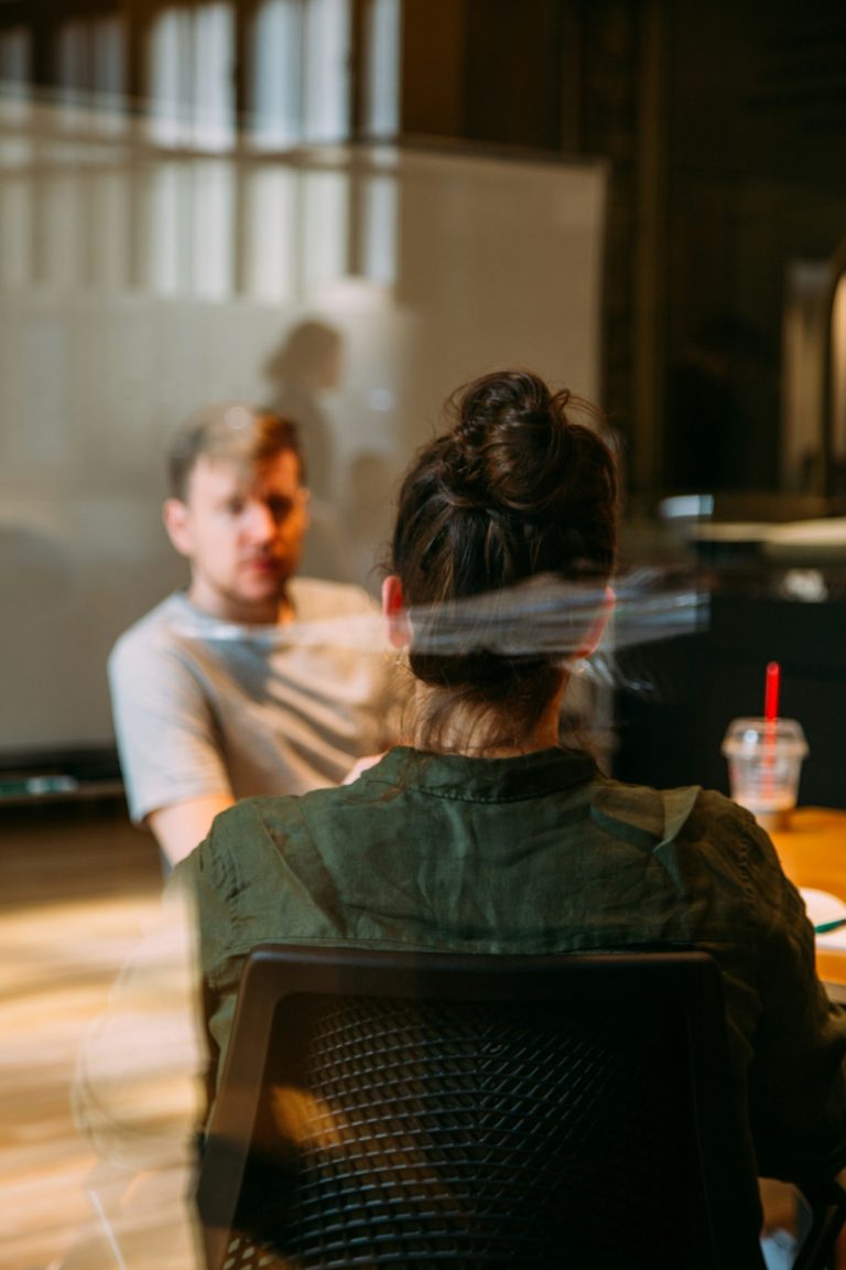 consultation around brand strategy between two professionals behind a glass separation